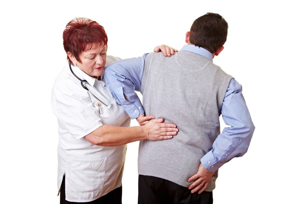 the doctor examines his back for pain